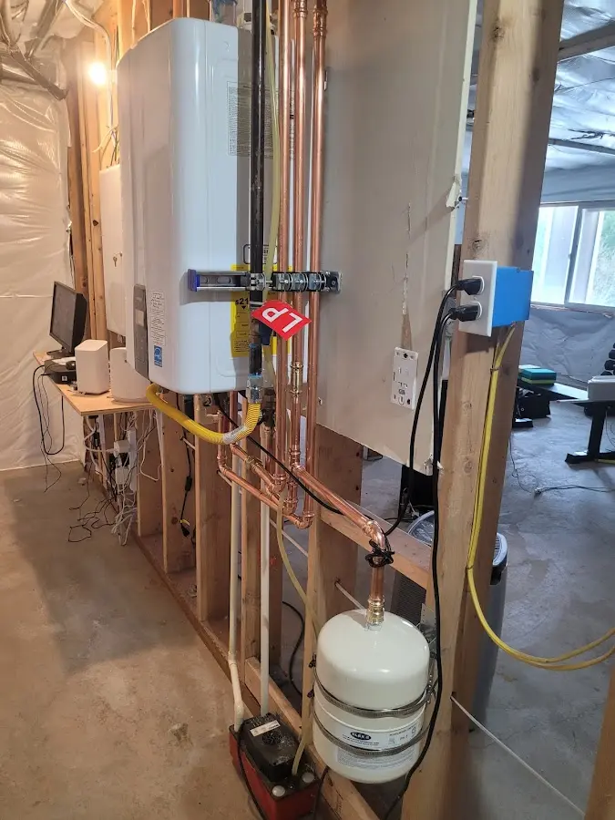 Licensed plumber repairing a kitchen sink in Bethel